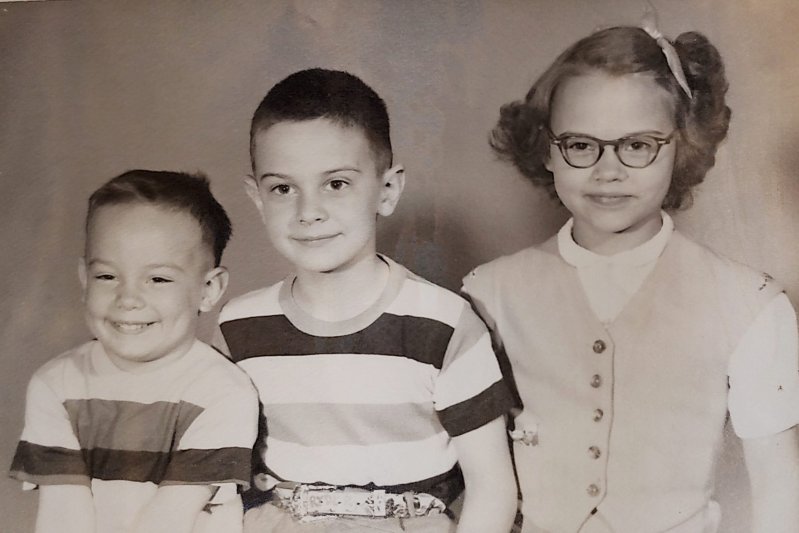 The young Hopkins kids in black-and-white photo smiling and wearing casual clothers.