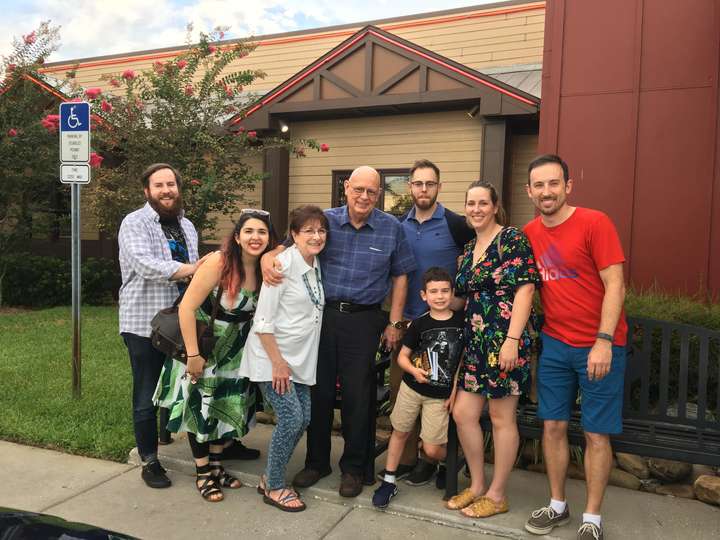 Group family shot outside of restaurant. 