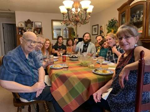 Dan's family eating around table.