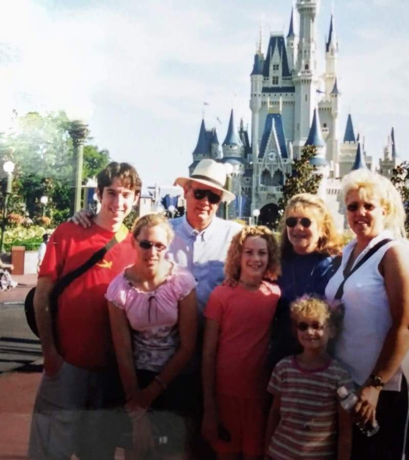 Hopkins family lined up for a photo in front of the castle in Magic Kingdom.