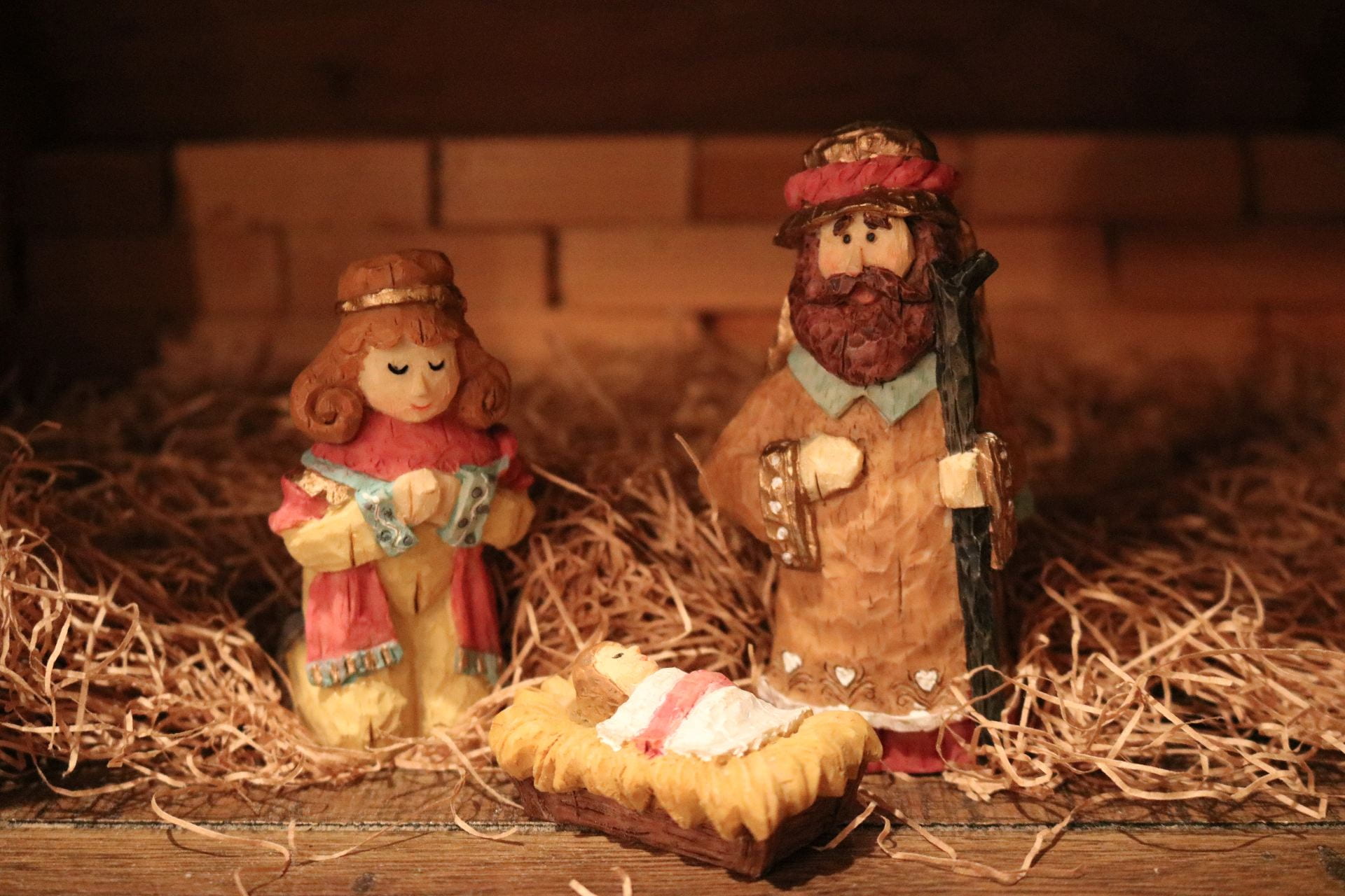 A colorful, carved nativity featuring Mary, Joseph, and Jesus.